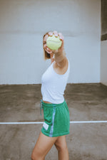 Person holding a tennis ball in an outdoor setting