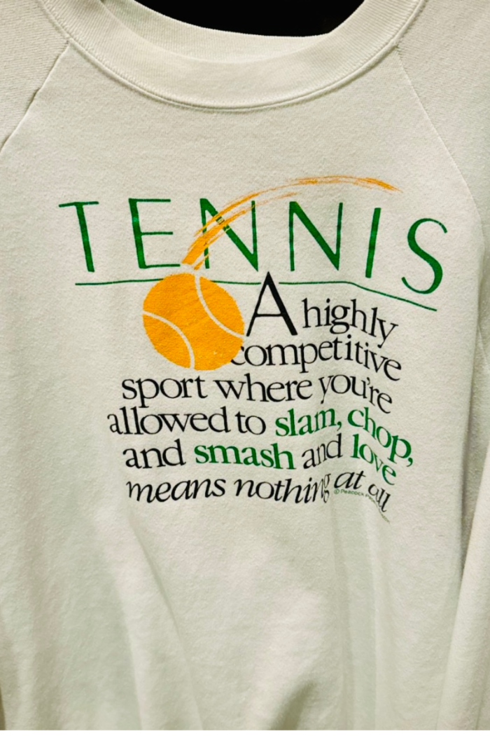 Tennis shirt graphic close up by Ace the Moon tennis brand that says "tennis a highly competitive sport where you're allowed to slam, chop and smash and love means nothing at all"