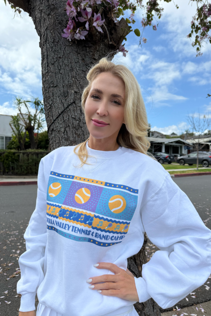 classic womens tennis crewneck sweatshirt worn by blonde female posing in front of a tree outside. sold by Ace the Moon premium tennis apparel brand