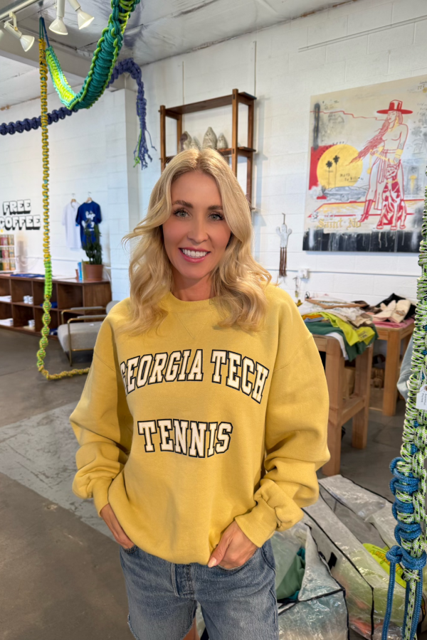 georgia tech tennis crewneck sweatshirt worn by woman in a store smiling