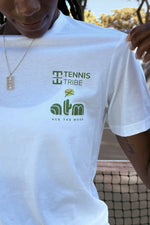 White t-shirt with 'Tennis Tribe' and 'atm' logos worn by a person.