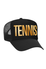 Black cap with 'TENNIS' in gold on a white background
