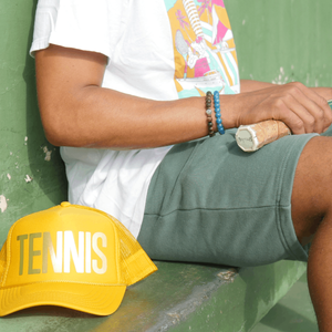 Tennis shorts in green with Tennis trucker hat in yellow by Ace the Moon Tennis Brand Los Angeles