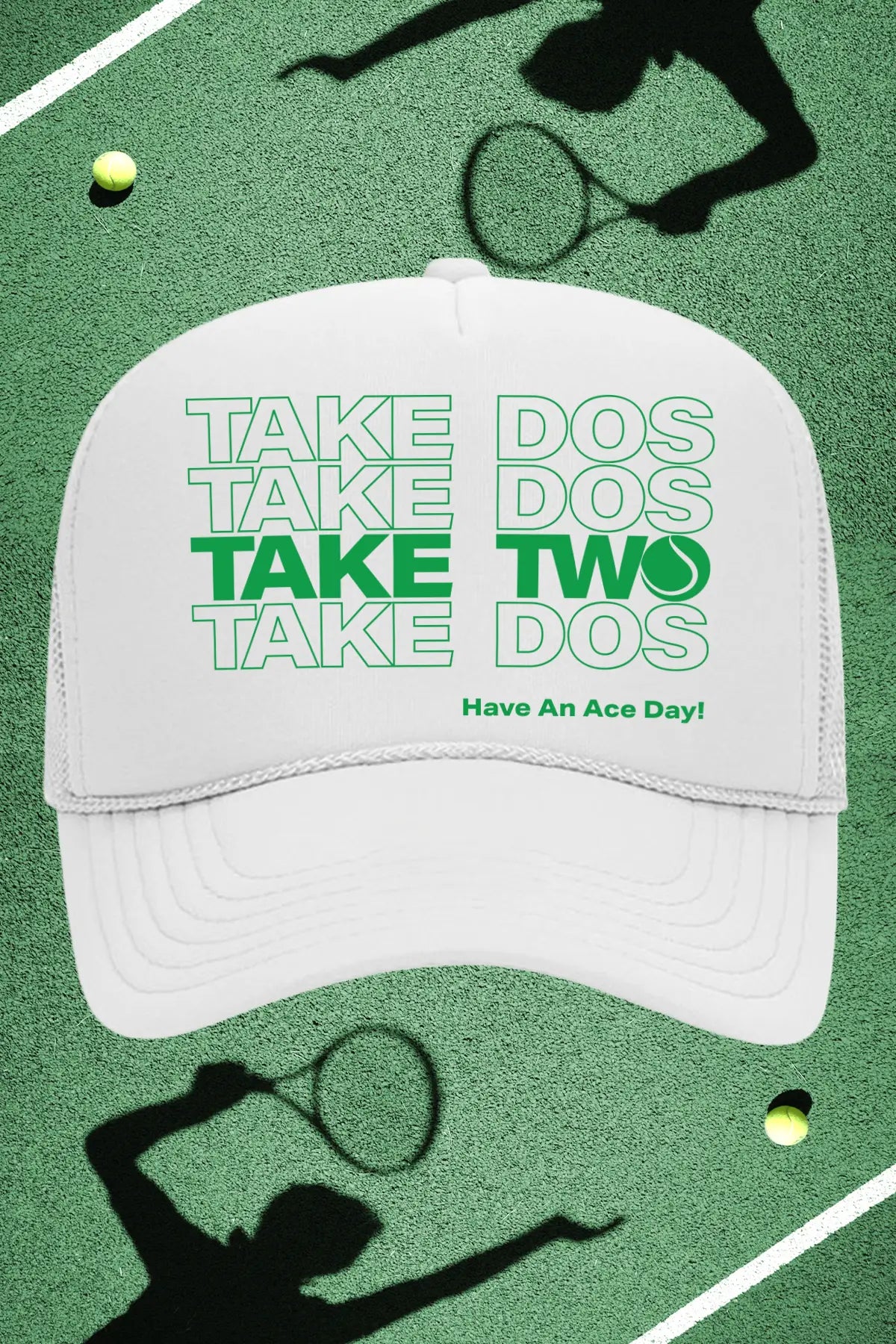 White cap with green text on a tennis court background