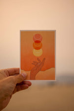 beautiful stationary card in sunburst orange sunset boho colors showcasing a hand throwing up a tennis ball that looks like a sunset. card by Ace the Moon premium tennis brand