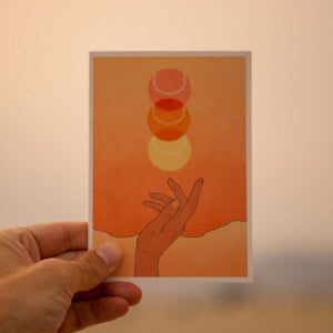 beautiful stationary card in sunburst orange sunset boho colors showcasing a hand throwing up a tennis ball that looks like a sunset. card by Ace the Moon premium tennis brand