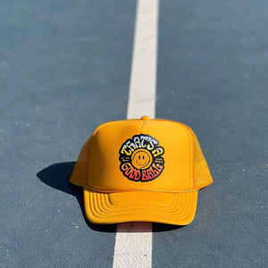 That's A Good Ball Tennis trucker hat in yellow by Ace the Moon LA tennis apparel brand. 