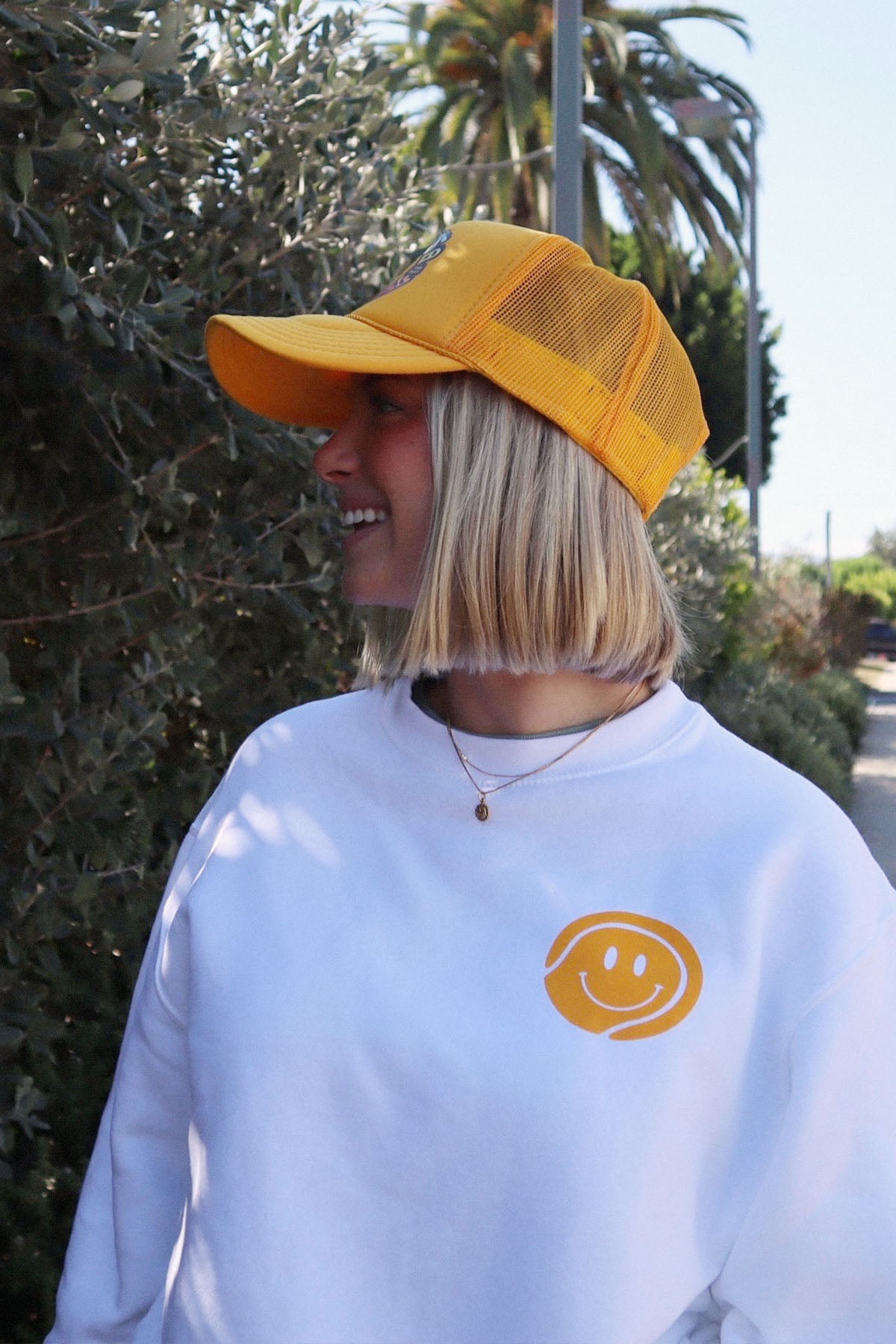 thats a good ball tennis trucker hat and crewneck sweatshirt by Ace the Moon tennis apparel brand LA
