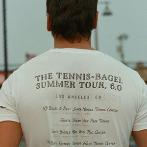 Los Angeles Tennis Bagel tour tee shirt in white by Ace the Moon Premium athleisure apparel brand. shirt worn by a man