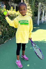 stoked 4 strokes kids hoodie in yellow worn by adorable kid holding a  tennis racket. sweatshirt made by Ace the Moon LA premium tennis apparel brand
